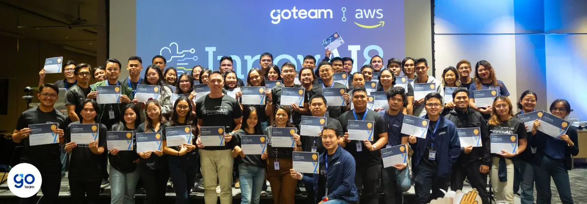 GoTeam and AWS participants holding certificates on stage at the InnovAI8 Summit